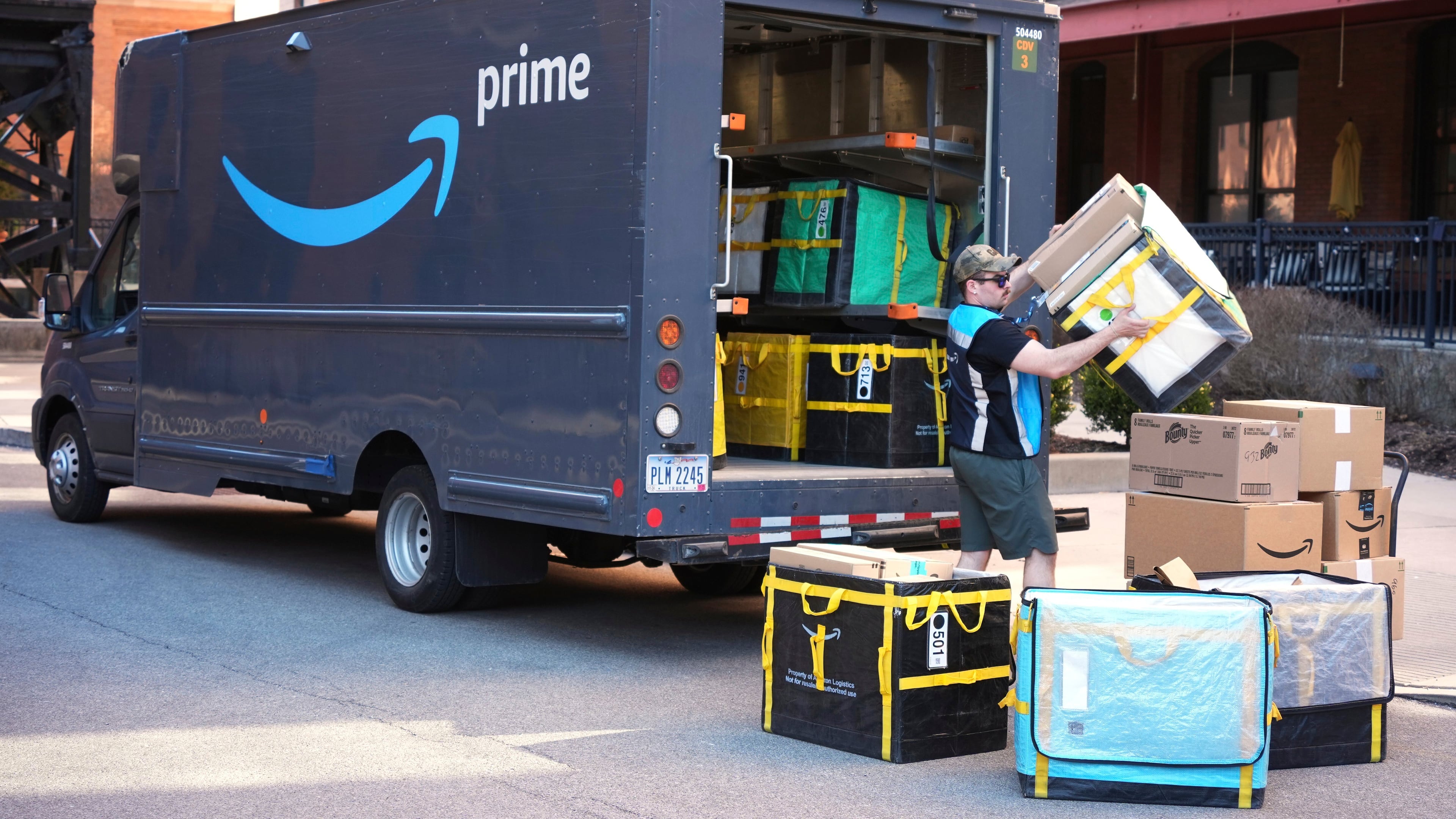 FILE - An Amazon Prime driver makes a delivery outside an apartment building in Pittsburgh, March 10, 2025. (AP Photo/Gene J. Puskar, File)