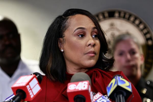 Surrounded by Fulton County law enforcement officials, District Attorney Fani Willis speaks during a press conference on Monday, August 29, 2022. Willis is weighing whether to indict former President Donald Trump for efforts to interfere in the 2020 election.  (Natrice Miller/ natrice.miller@ajc.com). 