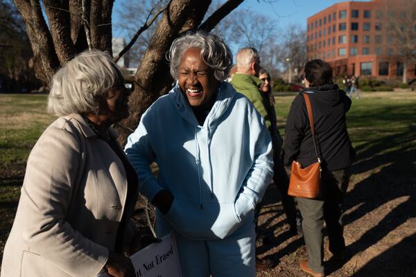 About 40 former and current residents of Decatur, including Wanda Sims Watters (left) and her sister Doris Sims Johnson, rallied Friday, Jan. 16, 2026, in support of a local historic designation for about 3 acres of vacant land that constitutes the only passive green space left in downtown Decatur. (Ben Gray for the AJC)