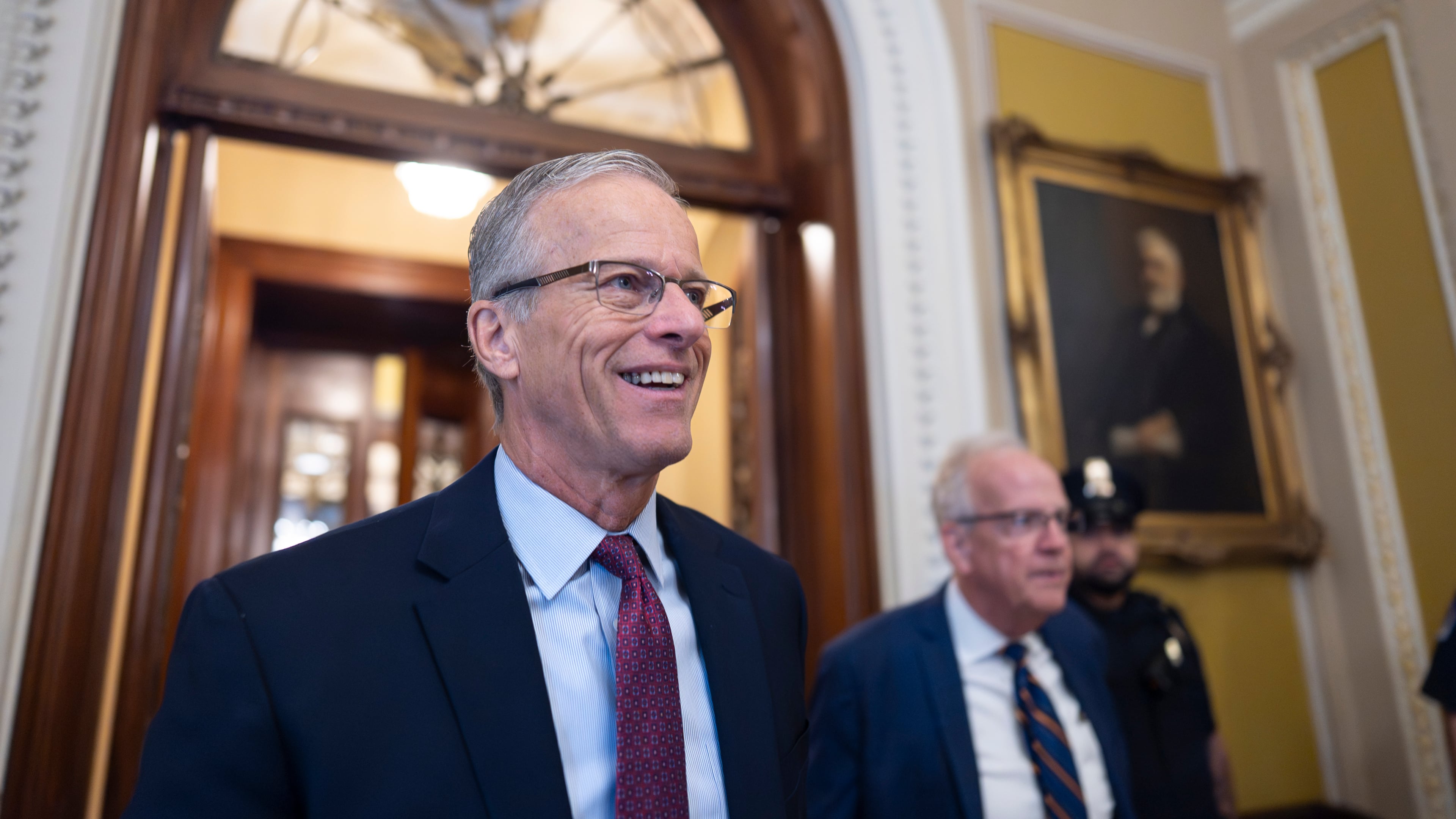 Senate Majority Leader John Thune, R-S.D., is met by reporters as he walks to his office while Congress works on a government funding solution, at the Capitol in Washington, Thursday, Sept. 18, 2025. (AP Photo/J. Scott Applewhite)