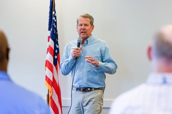 Gov. Brian Kemp speaks during a campaign stop for Republican U.S. Senate candidate Derek Dooley at Farmview Market in Madison last week. (Arvin Temkar/AJC)