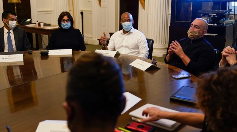 FILE - New York City Mayor Eric Adams, center, speaks during a cabinet meeting on his first day in office in New York, Jan. 1, 2022. To Adams' right is his Chief of Staff Frank Carone. (AP Photo/Seth Wenig, File)