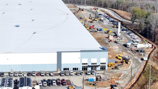 Construction equipment moves up and down on a site that will be the future home of ServerFarm's new Data Center in Covington on Wednesday, Dec. 10, 2025. They have proposed bringing their own fleet of generators on-site to supply power. (Miguel Martinez/AJC)