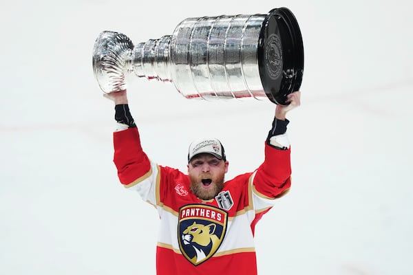 Florida Panthers' Sam Bennett (9) raises the Stanley Cup after defeating the Edmonton Oilers in Game 6 of the NHL hockey Stanley Cup Final in Sunrise, Fla., Tuesday, June 17, 2025. (Nathan Denette/The Canadian Press via AP)