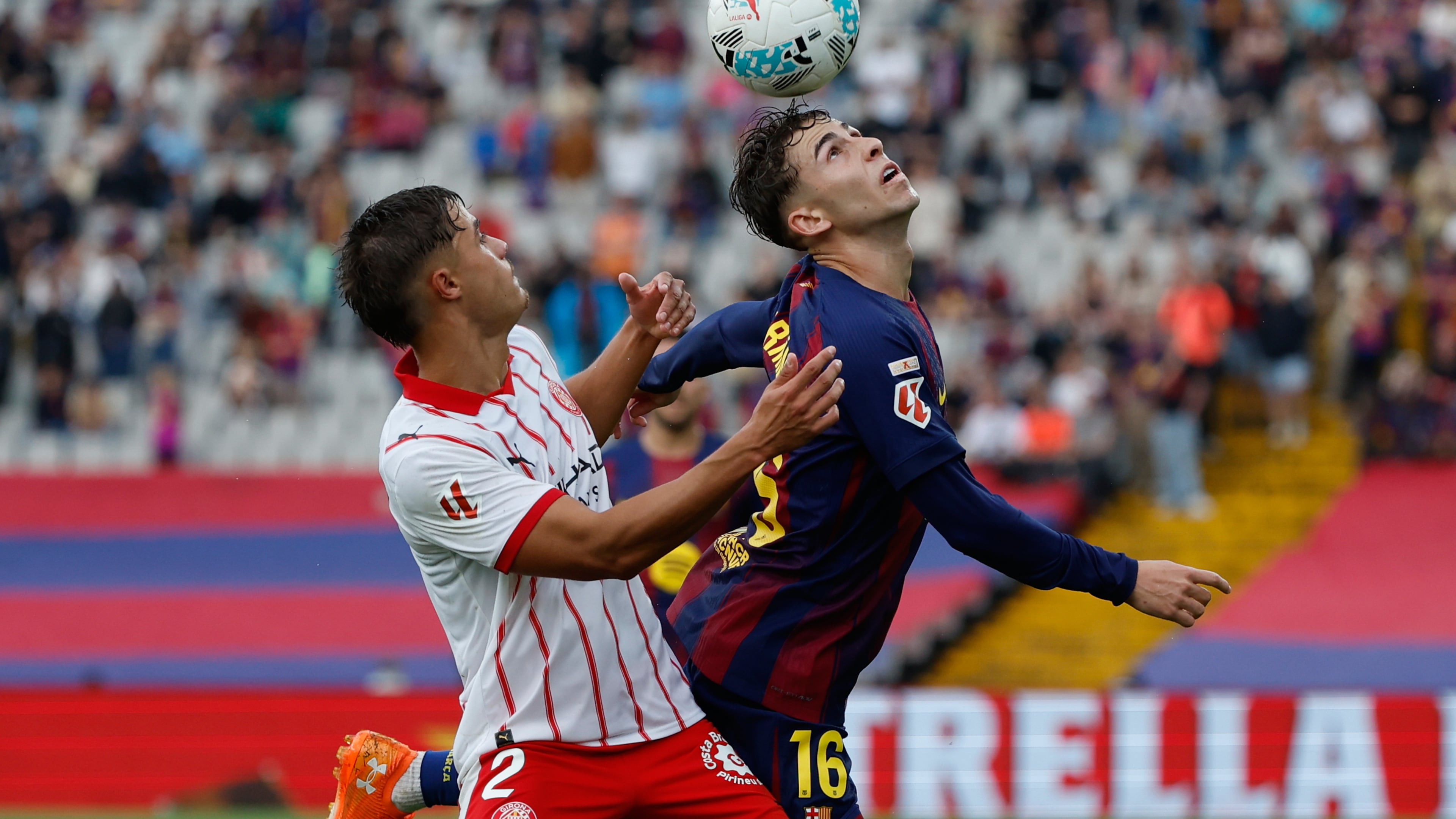 Girona's Hugo Rincon, left, and Barcelona's Fermin Lopez fight for the ball during a La Liga soccer match between Barcelona and Girona in Barcelona, Spain, Saturday, Oct. 18, 2025. AP Photo/Joan Monfort)