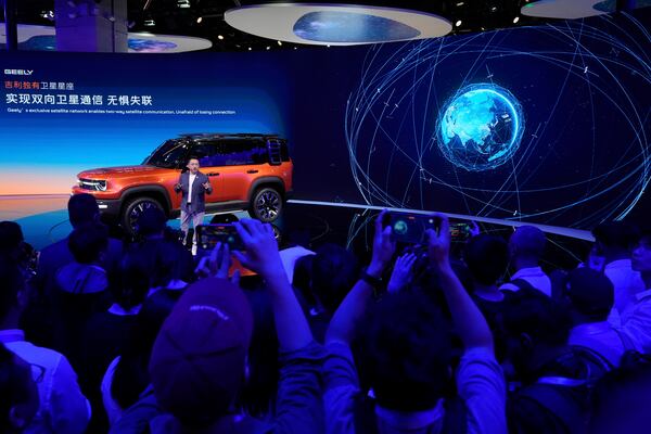 An executive from Chinese car manufacturer Geely talks the satellite communication capabilities of its Galaxy Cruiser during the Shanghai auto show on Wednesday, April 23, 2025. (AP Photo/Ng Han Guan)