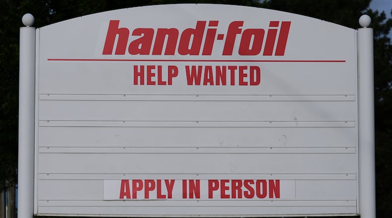 A help wanted sign is seen outside of a company in Wheeling, Ill., Monday, June 8, 2026. (AP Photo/Nam Y. Huh)