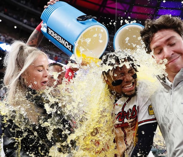 The downside of covering a World Series championship, as then-Bally South broadcaster Kelly Crull was doing here, is getting soaked by Powerade during the celebration. (Courtesy photo)