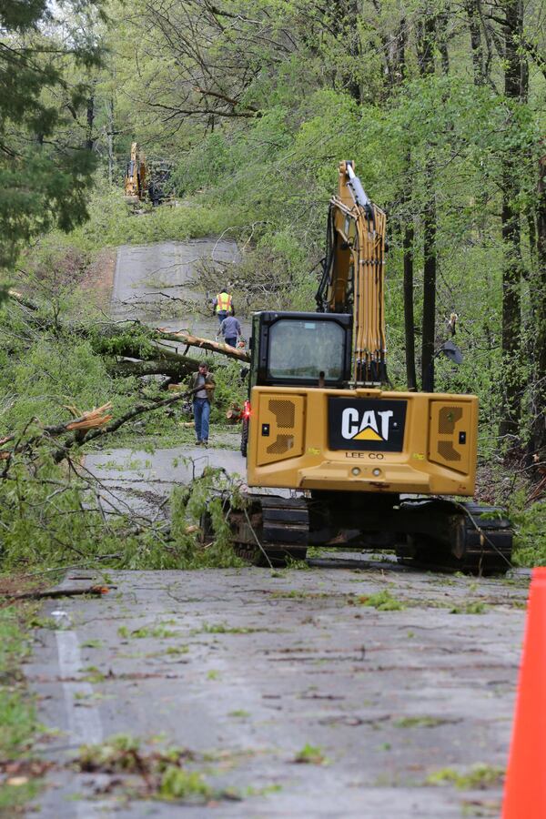 Road crews work to clear Lee County Rd. 681 in Saltillo, Miss, Sunday, April 6, 2025, of downed trees that blocked the road following the severe weather that passed through the area Saturday night. (Thomas Wells /The Northeast Mississippi Daily Journal via AP)