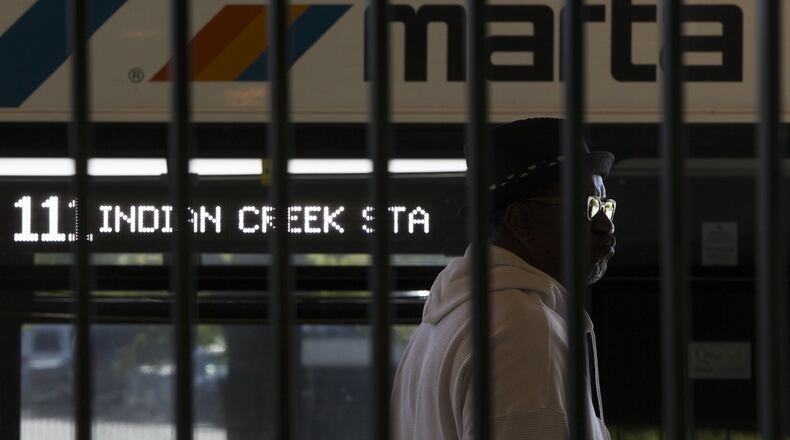 A man stands at the bus stop at the Indian Creek MARTA station in metro Atlanta on Wednesday, Oct. 25, 2017. Indian Creek is the easternmost stop on the MARTA train system as of October 2017 and is likely to remain that way for the foreseeable future. (CASEY SYKES / CASEY.SYKES@AJC.COM)