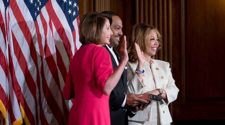 Rep. Lucy McBath (D-Ga.), accompanied by her husband, Curtis McBath, during a ceremonial swearing-in to the 116th Congress with House Speaker Nancy Pelosi (D-Calif.) in the Rayburn Room of the U.S. Capitol in Washington, Jan. 3, 2019. (Erin Schaff/The New York Times)