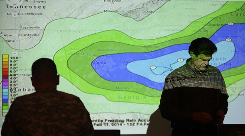 Chuck Ray, Director of Field Operations for GEMA, walks through a projected map of possible ice accumulation while working in the GEMA command center in southeast Atlanta.