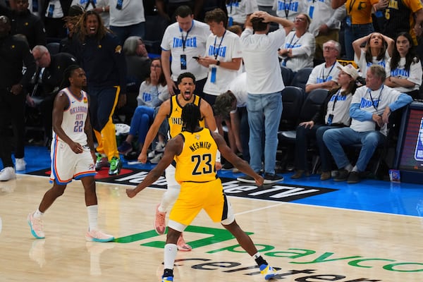 Indiana Pacers guard Tyrese Haliburton celebrates with forward Aaron Nesmith (23) after making a 3-pointer during the second half of Game 1 of the NBA Finals basketball series against the Oklahoma City Thunder Thursday, June 5, 2025, in Oklahoma City. (AP Photo/Nate Billings)