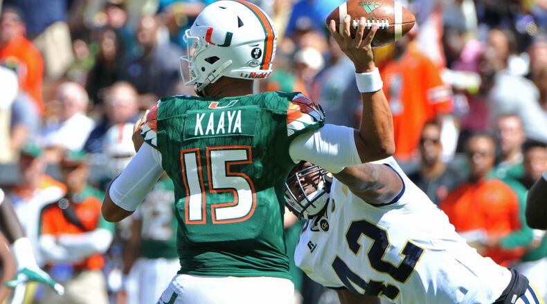 October 1, 2016 Atlanta - Miami Hurricanes quarterback Brad Kaaya (15) is tackled by Georgia Tech Yellow Jackets defensive end KeShun Freeman (42) in the first half at Bobby Dodd Stadium on Saturday, October 1, 2016. HYOSUB SHIN / HSHIN@AJC.COM