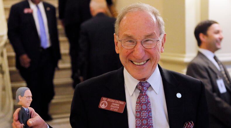 Rep. Brooks Coleman, R - Duluth, shows off a bobble head doll of himself he was presented on the final day of the 2018 General Assembly in honor of his retirement.