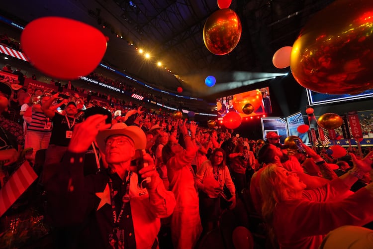 Attendees cheer at the end of the Republican midterm convention on Thursday in Dallas. (Julio Cortez/AP)