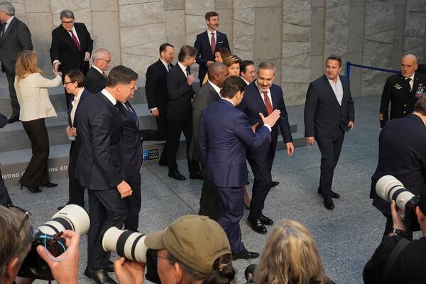 U.S. Secretary of State Marco Rubio, center in blue suit, shakes hands Turkish Foreign Minister Hakan Fidan after a group photo of NATO foreign ministers at NATO headquarters Brussels, Thursday, April 3, 2025. (AP Photo/Jacquelyn Martin, Pool)