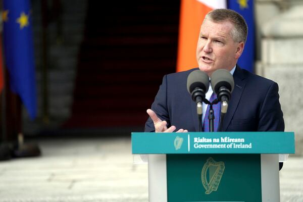 EU Commissioner for Democracy, Justice, the Rule of Law and Consumer Protection Michael McGrath speaks during a joint press conference with Taoiseach Micheal Martin, not pictured, following their meeting at Government Buildings, over the 20% tariff on imports from the EU announced by US President Donald Trump, which will significantly impact Ireland, in Dublin, Thursday April 3, 2025. (Brian Lawless/PA via AP)