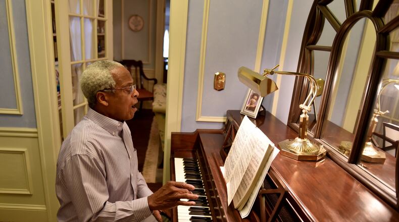 Sam Hagan, a retired biology teacher and a dedicated home improver, built a second career as a vocalist. Here he glances at a piece of music he will sing in the 40th annual “Messiah” presented at St. Luke’s Episcopal Church. BRANT SANDERLIN/BSANDERLIN@AJC.COM