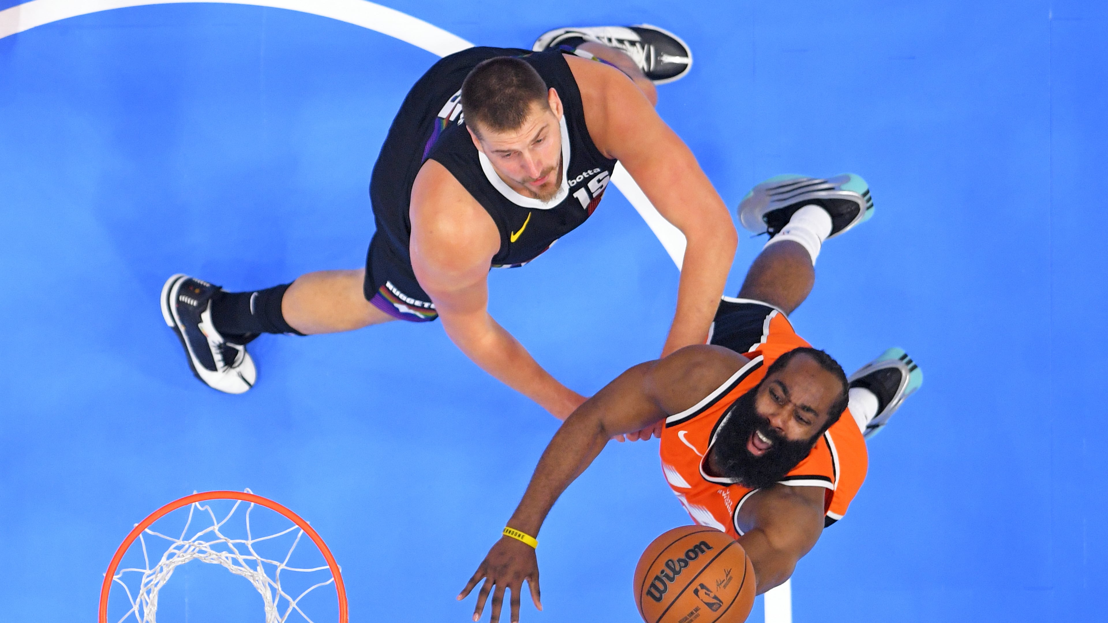 Los Angeles Clippers guard James Harden, right, shoots as Denver Nuggets center Nikola Jokic defends during the first half of an NBA basketball game Wednesday, Nov. 12, 2025, in Inglewood, Calif. (AP Photo/Mark J. Terrill)