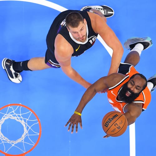 Los Angeles Clippers guard James Harden, right, shoots as Denver Nuggets center Nikola Jokic defends during the first half of an NBA basketball game Wednesday, Nov. 12, 2025, in Inglewood, Calif. (AP Photo/Mark J. Terrill)