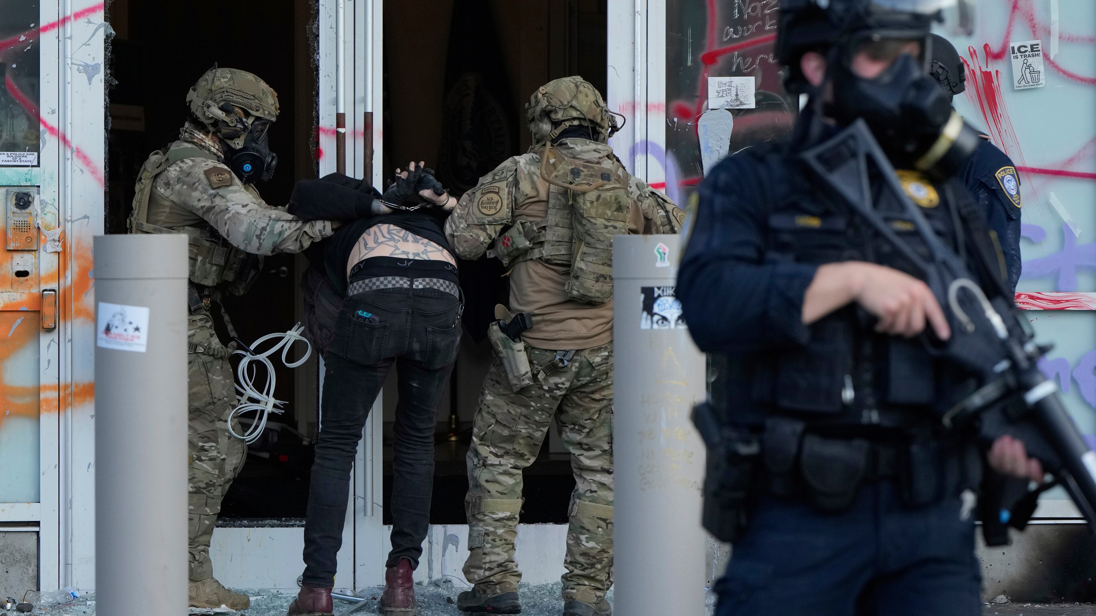 FILE - U.S. Customs and Border Protection agents detain a man outside the U.S. Immigration and Customs building during a protest in Portland, Ore., June 14, 2025. (AP Photo/Jenny Kane, File)