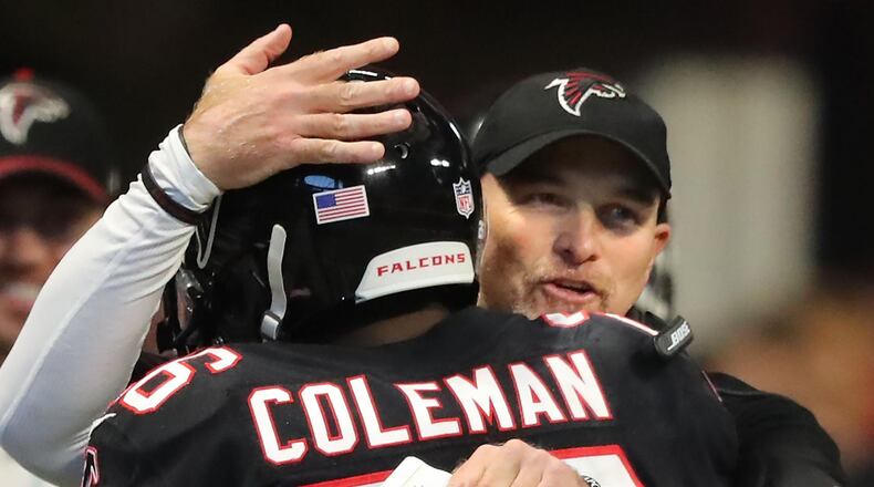 November 26, 2017 Atlanta: Falcons head coach Dan Quinn gives running back Tevin Coleman a hug after his first of two touchdown runs against the Buccaneers during the second half on the way to a 34-20 victory in a NFL football game on Sunday, November 26, 2017, in Atlanta. Curtis Compton/ccompton@ajc.com