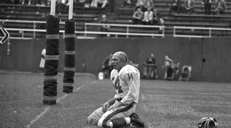 Giants quarterback Y.A. Tittle, in the final season of his career, was photographed helmet-less, bloodied and kneeling immediately after having been knocked to the ground by John Baker of the Pittsburgh Steelers and throwing an interception that was returned for a touchdown at the old Pitt Stadium in 1964.