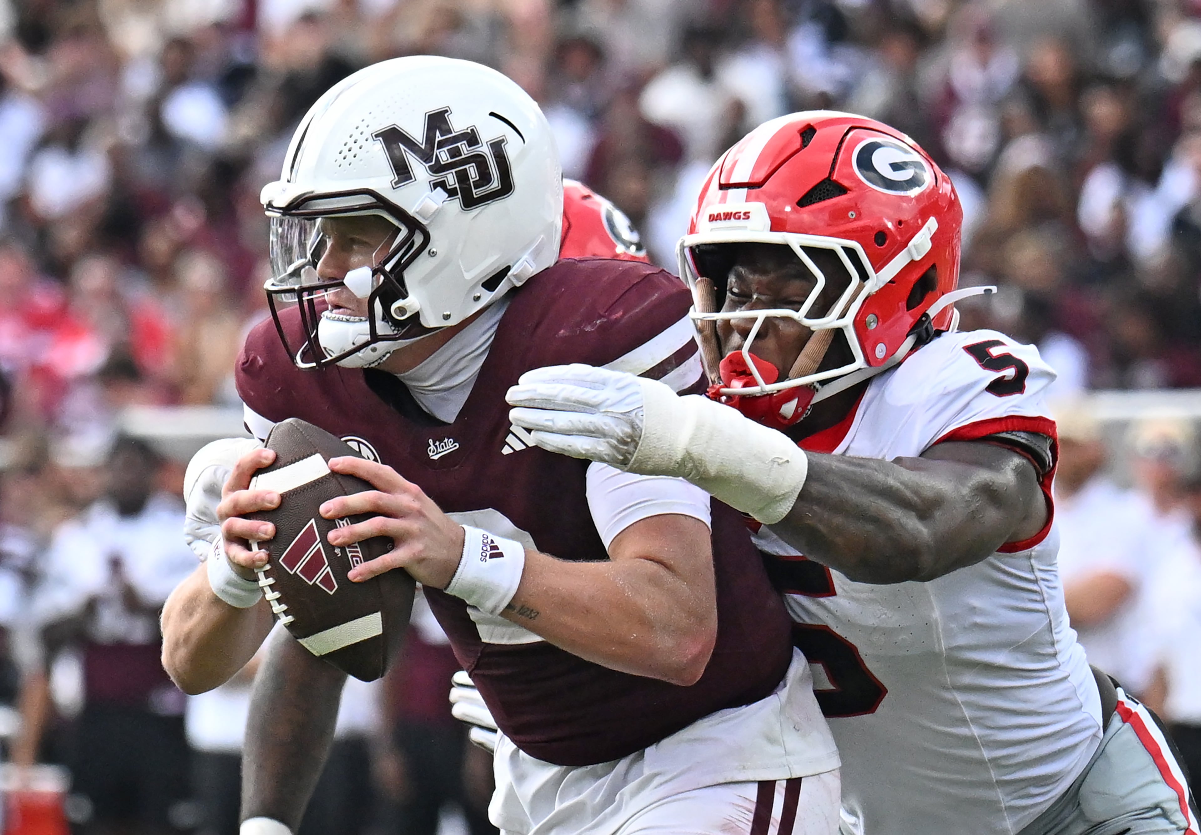 Mississippi State quarterback Blake Shapen (2) is sacked by Georgia linebacker Raylen Wilson (5) during the first half in an NCAA football game at Davis Wade Stadium, Saturday, November 8, 2025, in Starkville, Mississippi. (Hyosub Shin / AJC)