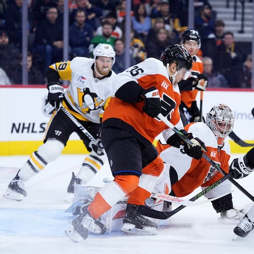 Pittsburgh Penguins' Sidney Crosby (87) scores a goal against Philadelphia Flyers' Dan Vladar (80) and Emil Andrae (36) during the first period of an NHL hockey game Monday, Dec. 1, 2025, in Philadelphia. (AP Photo/Matt Slocum)
