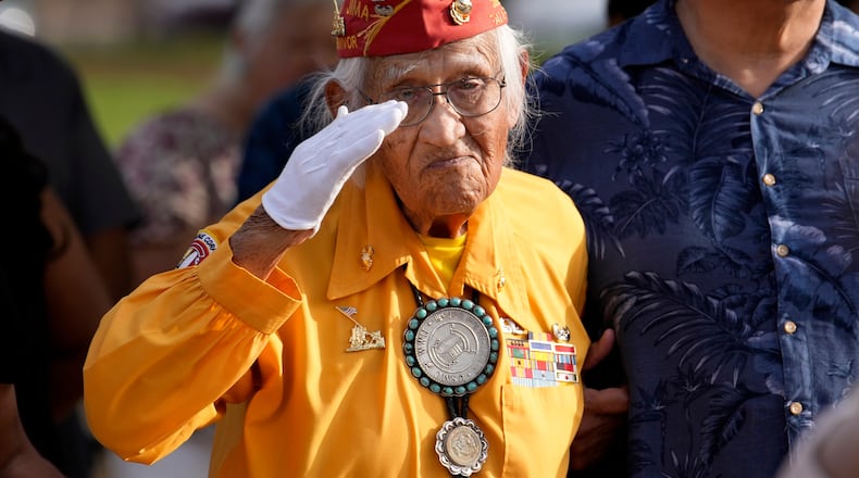 Navajo Code Talker Thomas Begay salutes during the national anthem during a ceremony on Navajo Code Talkers Day, Friday, Aug. 14, 2026, in Phoenix. (AP Photo/Ross D. Franklin)