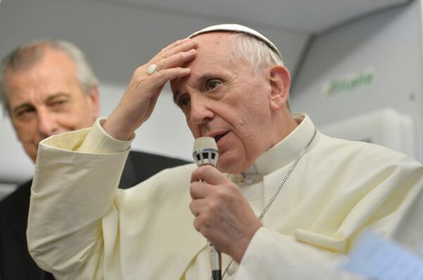 FILE - Pope Francis speaks during a news conference aboard the papal flight on its way back from Brazil, Monday, July 29, 2013. Pope Francis reached out to gays on Monday, saying he wouldn't judge priests for their sexual orientation in a remarkably open and wide-ranging news conference as he returned from his first foreign trip. "If someone is gay and he searches for the Lord and has good will, who am I to judge?" Francis asked. (Luca Zennaro/Pool Photo via AP, File)