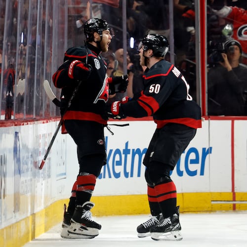 Carolina Hurricanes' Mark Jankowski, left, celebrates after his goal with Eric Robinson (50) during the third period in Game 2 of the NHL hockey Stanley Cup Final series against the Vegas Golden Knights in Raleigh, N.C., Thursday, June 4, 2026. (AP Photo/Karl DeBlaker)
