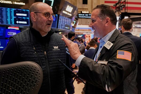 Specialist Peter Giacchi, left, and trader Edward Curran work on the floor of the New York Stock Exchange, Friday, April 11, 2025. (AP Photo/Richard Drew)