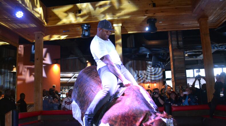 Atlanta Braves Hall of Famer Andruw Jones rides the mechanical bull at the PBR Atlanta, a cowboy-style bar opening in the Battery Atlanta on May 5, 2017. The mechanical bull "Druw" is named after the 10-time Gold Glove winner.