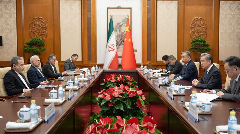 In this photo released by Xinhua News Agency, Chinese Foreign Minister Wang Yi, second right, talks to his Iranian Counterpart Abbas Araghchi, left, during the bilateral meeting in Beijing, Wednesday, May 6, 2026. (Cai Yang/Xinhua via AP)