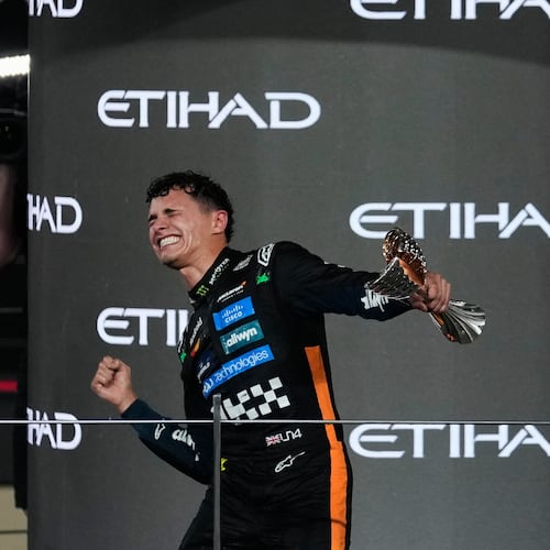 McLaren driver Lando Norris of Britain celebrates after becoming a world champion after the Formula One Abu Dhabi Grand Prix at the Yas Marina Circuit in Abu Dhabi, UAE, Sunday, Dec. 7, 2025. (AP Photo/Altaf Qadri)
