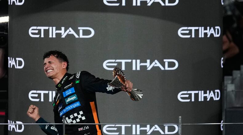McLaren driver Lando Norris of Britain celebrates after becoming a world champion after the Formula One Abu Dhabi Grand Prix at the Yas Marina Circuit in Abu Dhabi, UAE, Sunday, Dec. 7, 2025. (AP Photo/Altaf Qadri)
