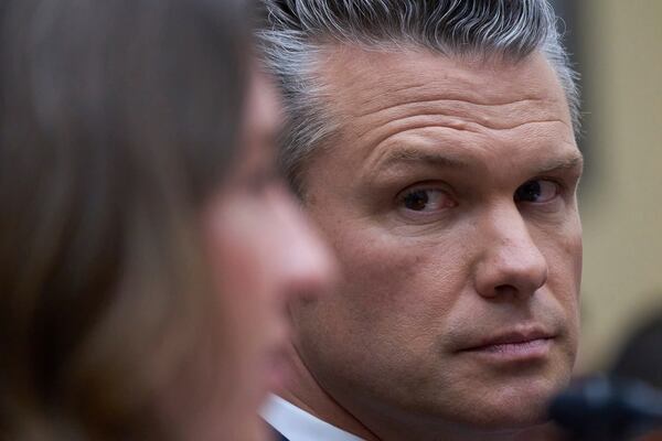 Secretary of Defense Pete Hegseth looks at Bryn MacDonnell, left, acting chief financial officer at the Department of Defense, as he fields questions on the Pentagon budget from the House Armed Services Committee, at the Capitol in Washington, Thursday, June 12, 2025. (AP Photo/J. Scott Applewhite)