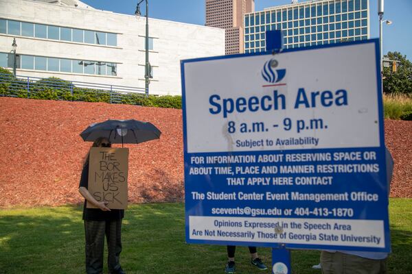 Wendy Simonds holds a sign during a demonstration at the Georgia State University Campus in Atlanta, Monday, September 13, 2021. Faculty members and students from about 20 public colleges and universities in Georgia started a weeklong series of demonstrations demanding tougher COVID-19 safety measures, such as a mask mandate, in all campus buildings. (Alyssa Pointer/Atlanta Journal Constitution)