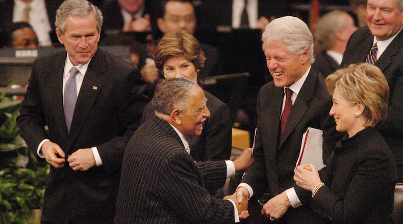 060207 - LITHONIA, GA -- The funeral service for Coretta Scott King, wife of Dr. Martin Luther King, Jr., was held Tuesday, Feb. 7, 2006 at the New Birth Missionary Baptist Church. Rev. Joseph Lowery (cq) gets a laugh from former President Bill Clinton and his wife, Sen. Hillary Clinton, after he honored King. Left is Pres. George Bush and his wife, Laura. (RENEE HANNANS HENRY/AJC staff)