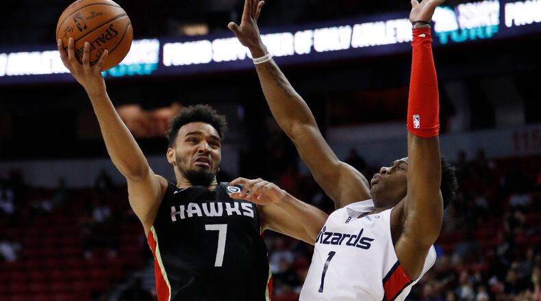 The Hawks' Amine Noua (left) shoots over Washington Wizards' Admiral Schofield. Noua scored seven points. (AP Photo/John Locher)