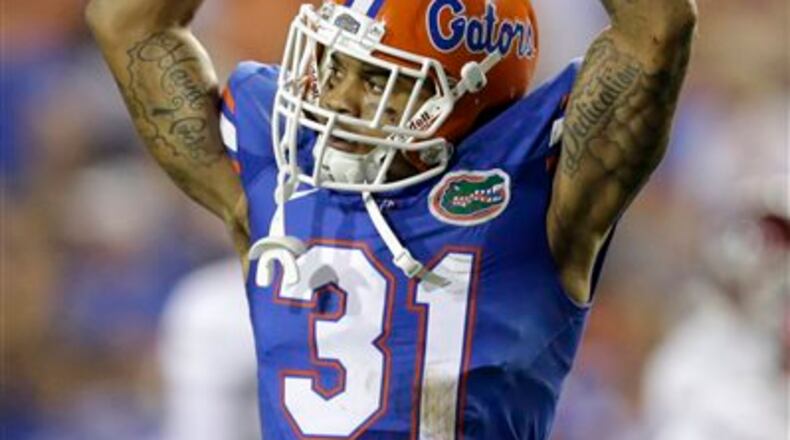 FILE - In this Sept. 5, 2015, file photo, Florida defensive back Jalen Tabor raises his arms to fans as they cheer during the first half of an NCAA college football game against New Mexico State in Gainesville, Fla. Florida coach Jim McElwain has suspended Tabor and tight end C'yontai Lewis on Wednesday, Aug. 17, 2016, saying neither will play in the team's season opener against UMass. (AP Photo/John Raoux, File)