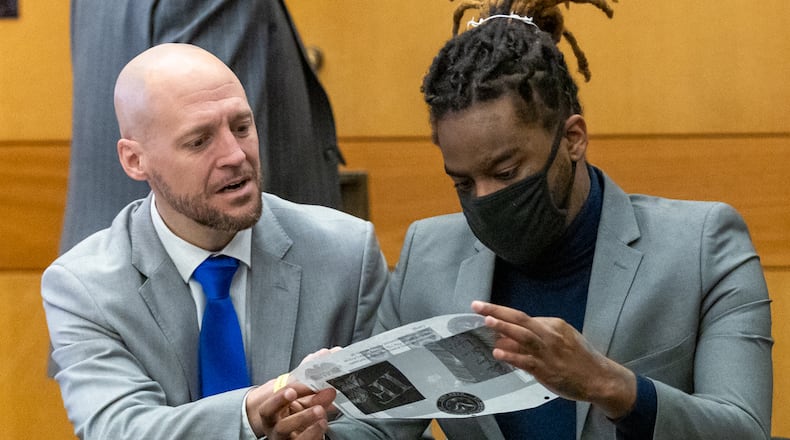 Attorney, Max Schardt, left, talks with his client, Shannon Stillwell, during jury selection in the sweeping Fulton County "Young Slime Life" trial. File photo.  (Steve Schaefer/steve.schaefer@ajc.com)