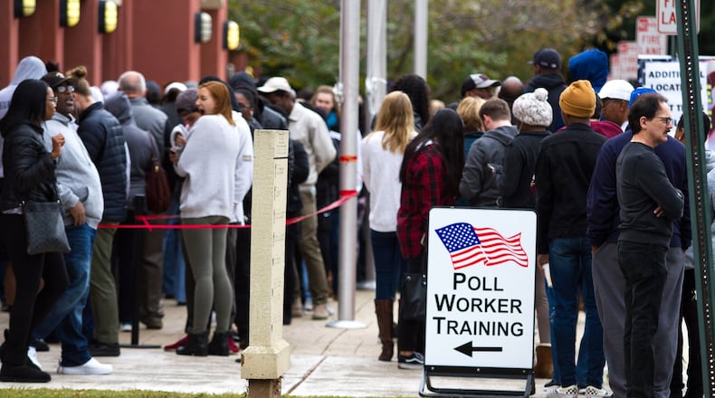 People wait in a long line to vote Saturday at the Cobb County Board of Elections and Registration Office in Marietta. STEVE SCHAEFER / SPECIAL TO THE AJC