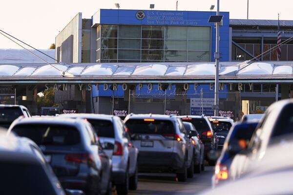 FILE - Vehicles wait in line to cross the border into the United States at the San Ysidro Port of Entry, March 18, 2025, in Tijuana, Mexico. (AP Photo/Gregory Bull, File)