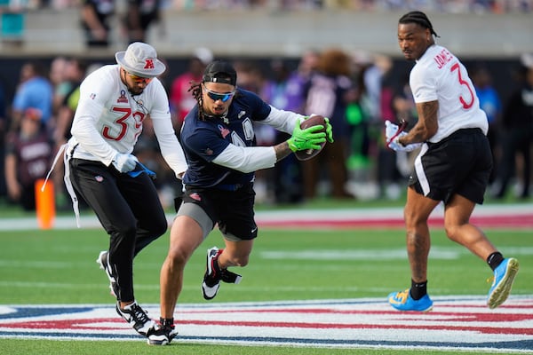 FILE - NFC wide receiver Jaxon Smith-Njigba (11), of the Seattle Seahawks, tries to evade AFC safety Minkah Fitzpatrick, of the Pittsburgh Steelers, left, during the flag football event at the NFL Pro Bowl, Sunday, Feb. 2, 2025, in Orlando. (AP Photo/Chris O'Meara, File)