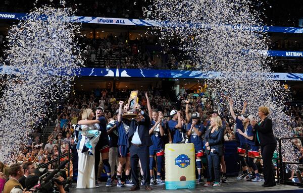 UConn head coach Geno Auriemma holds up the championship trophy after UConn defeated South Carolina in the national championship game at the Final Four of the women's NCAA college basketball tournament, Sunday, April 6, 2025, in Tampa, Fla. (AP Photo/John Raoux)