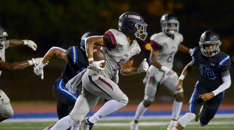 Alpharetta's Jaden Slocum (5) intercepts a pass and runs for yardage in the first half of a game at Centennial in 2019. (Daniel Varnado/Special)
