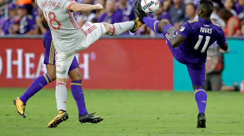 Atlanta United's Jeff Larentowicz (18) and Orlando City's Carlos Rivas (11) vie for possession of the ball during the first half of an MLS soccer match, Friday, July 21, 2017, in Orlando, Fla. (AP Photo/John Raoux)